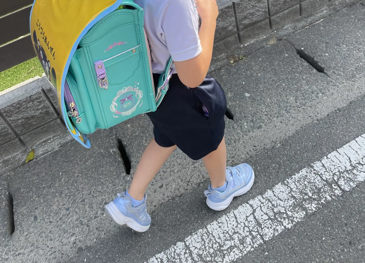 ランドセルにGPSを入れて通学する子どもの様子